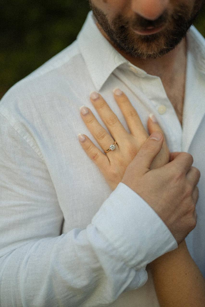 Maria’s engagement ring as Ben holds her hand