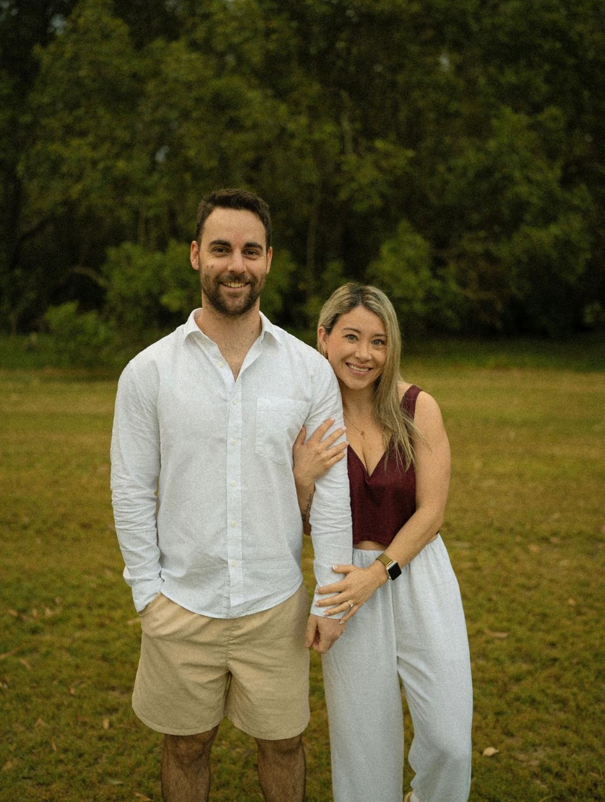 Ben and Maria smiling together in a garden